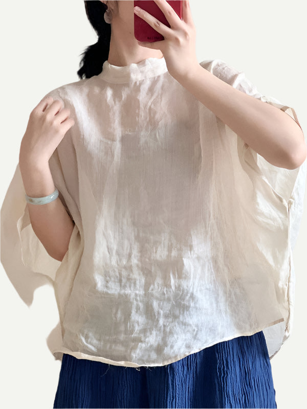 Model wears Batwing Sleeves Cream Lace-Up Linen Shirt styled with blue pants and jade bracelet.