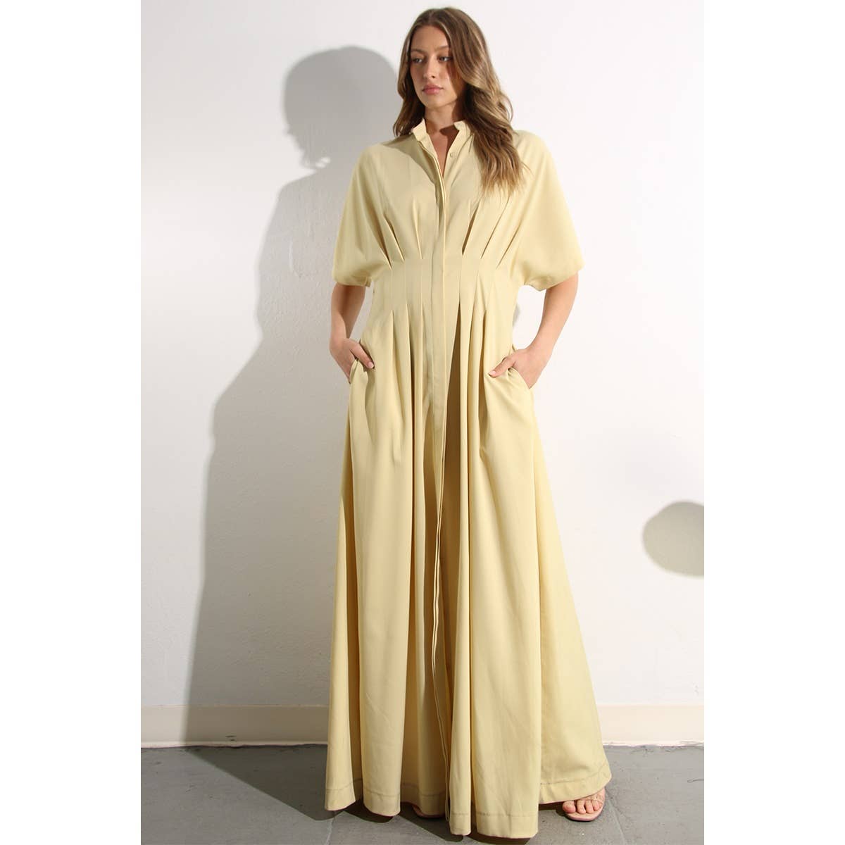 Model showing pockets on North and Five's Butter Yellow Long Button-Down Dress.
