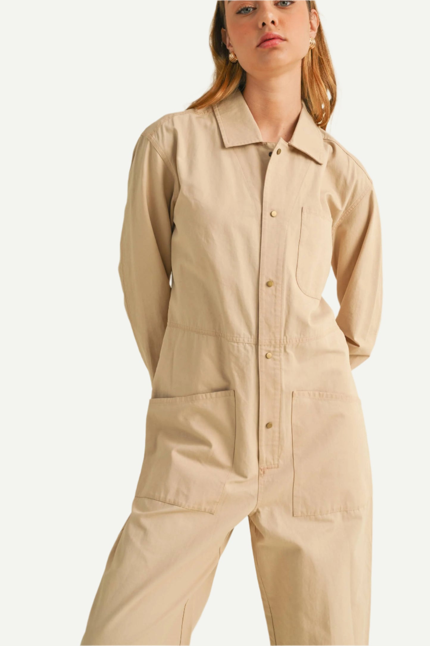 Close up of North and Five Dune Utility Jumpsuit showing button and pocket detail.