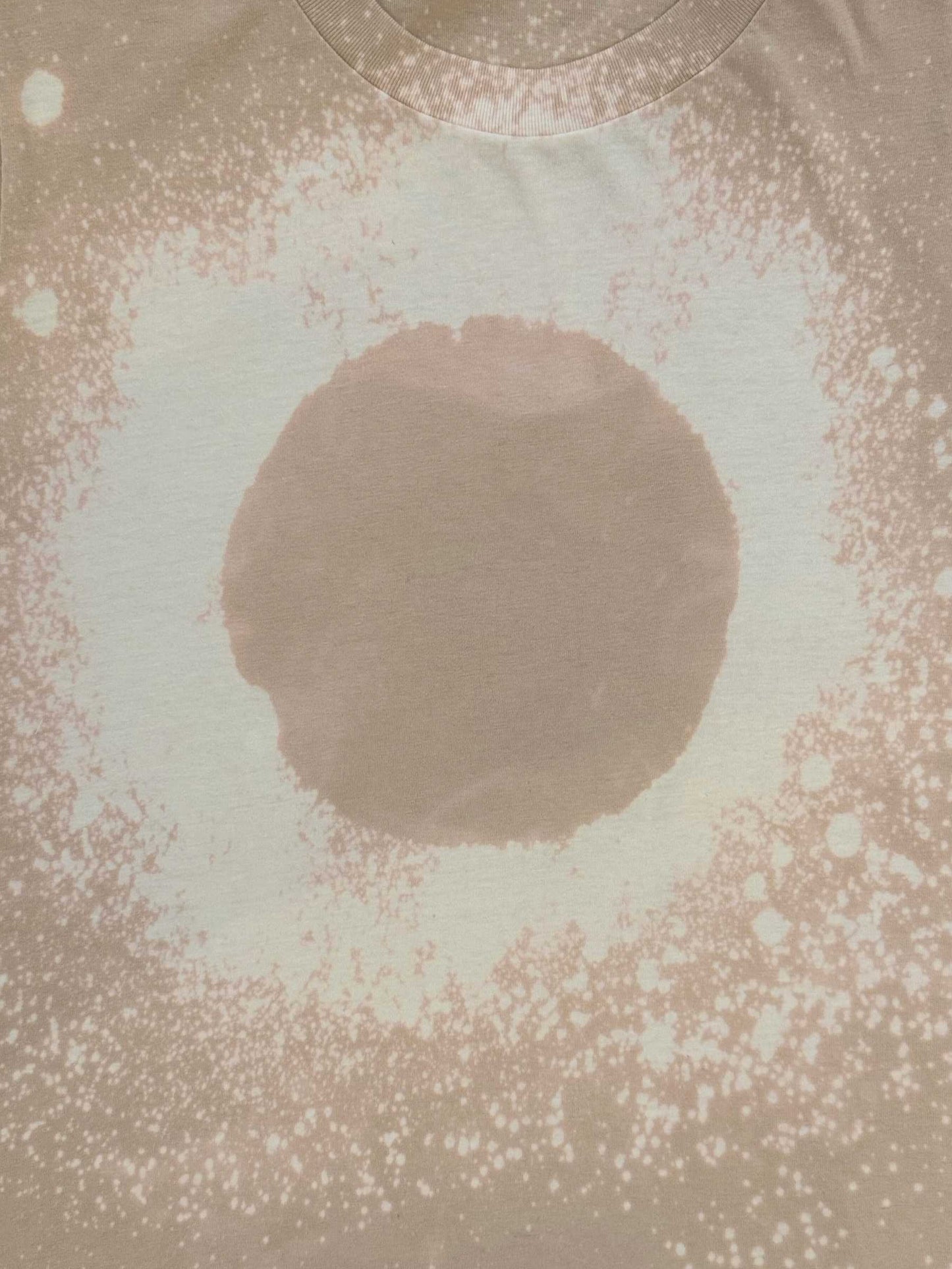 Close up of Luminary Organic Tee by Mira Blackman in neutral showing circle detail.