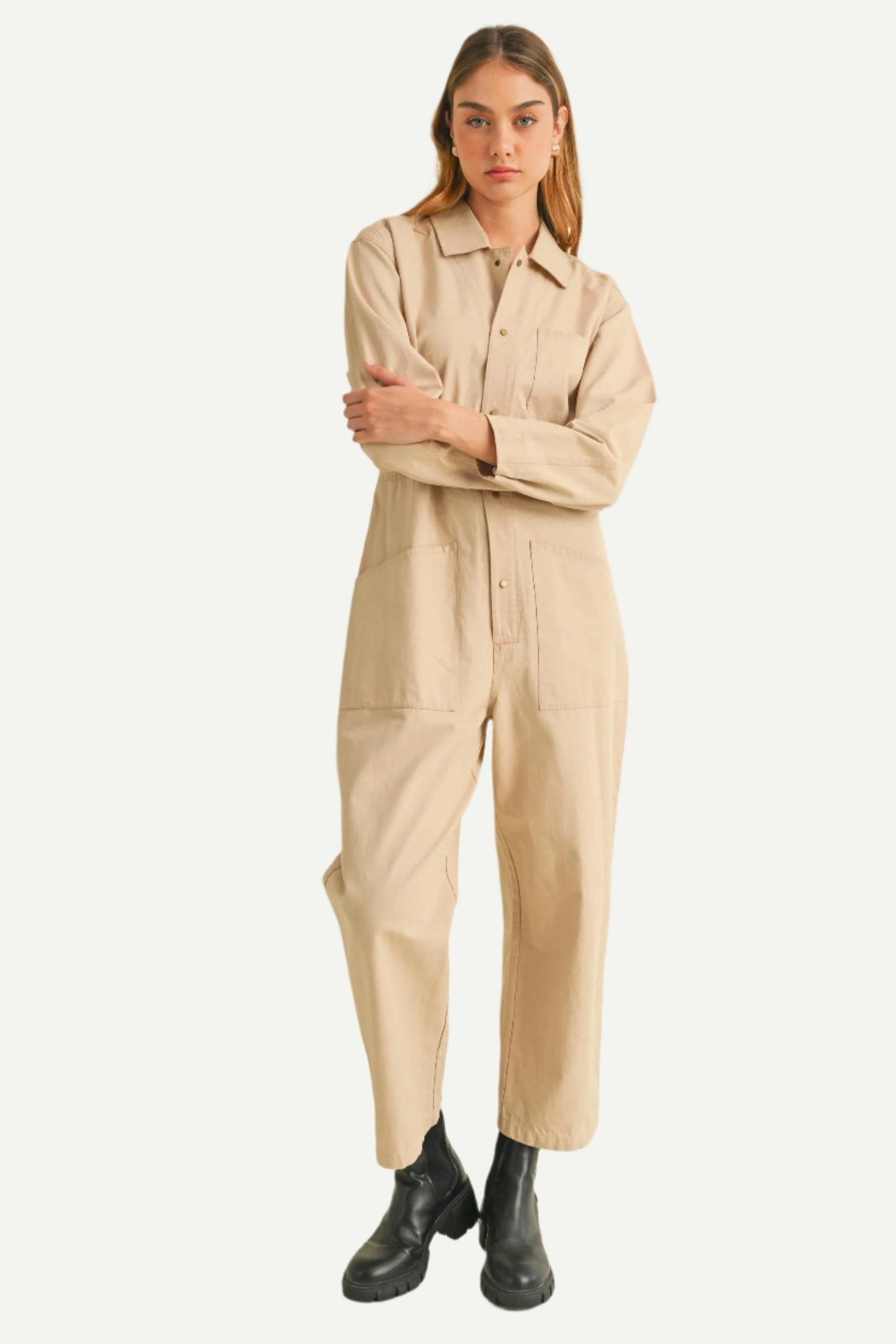 Main image of Relaxed-fit cotton utility jumpsuit in beige with pockets and long sleeves, styled with black boots