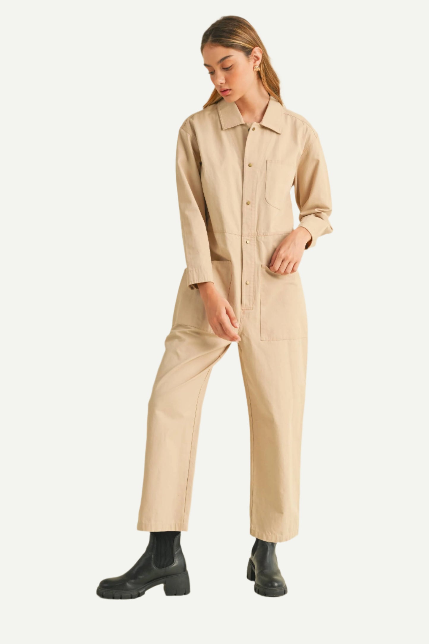 North and Five Dune Utility Jumpsuit showing model using pocket and styled with black boots