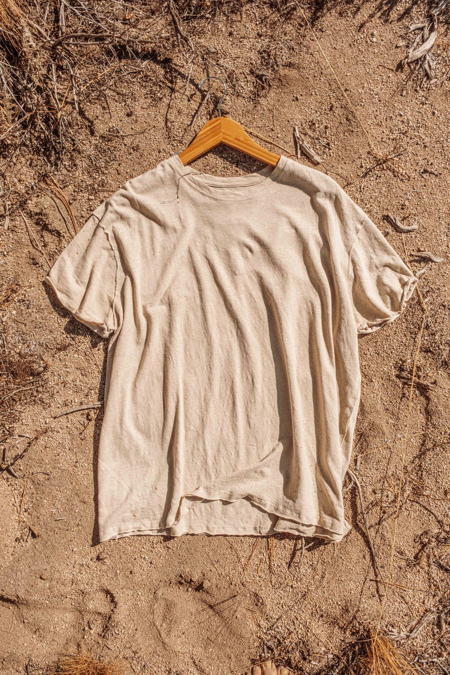 Stylized Flat lay of Hemp Organic Cotton Unisex T-Shirt outside in earth.