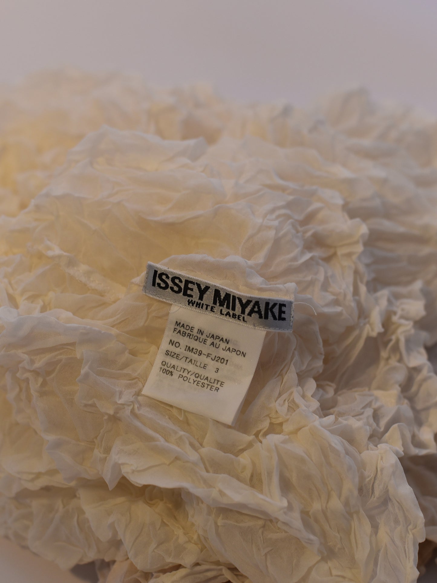Close up of label on Issey Miyake crinkled blouse from S/S 2003 collection