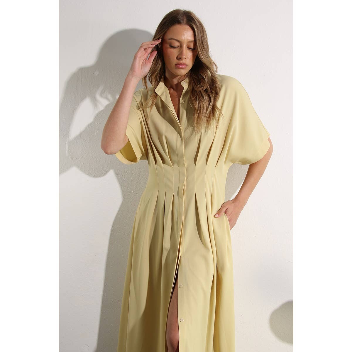 Close up of North and Five's Butter Yellow Long Button-Down Dress showing leg slit.