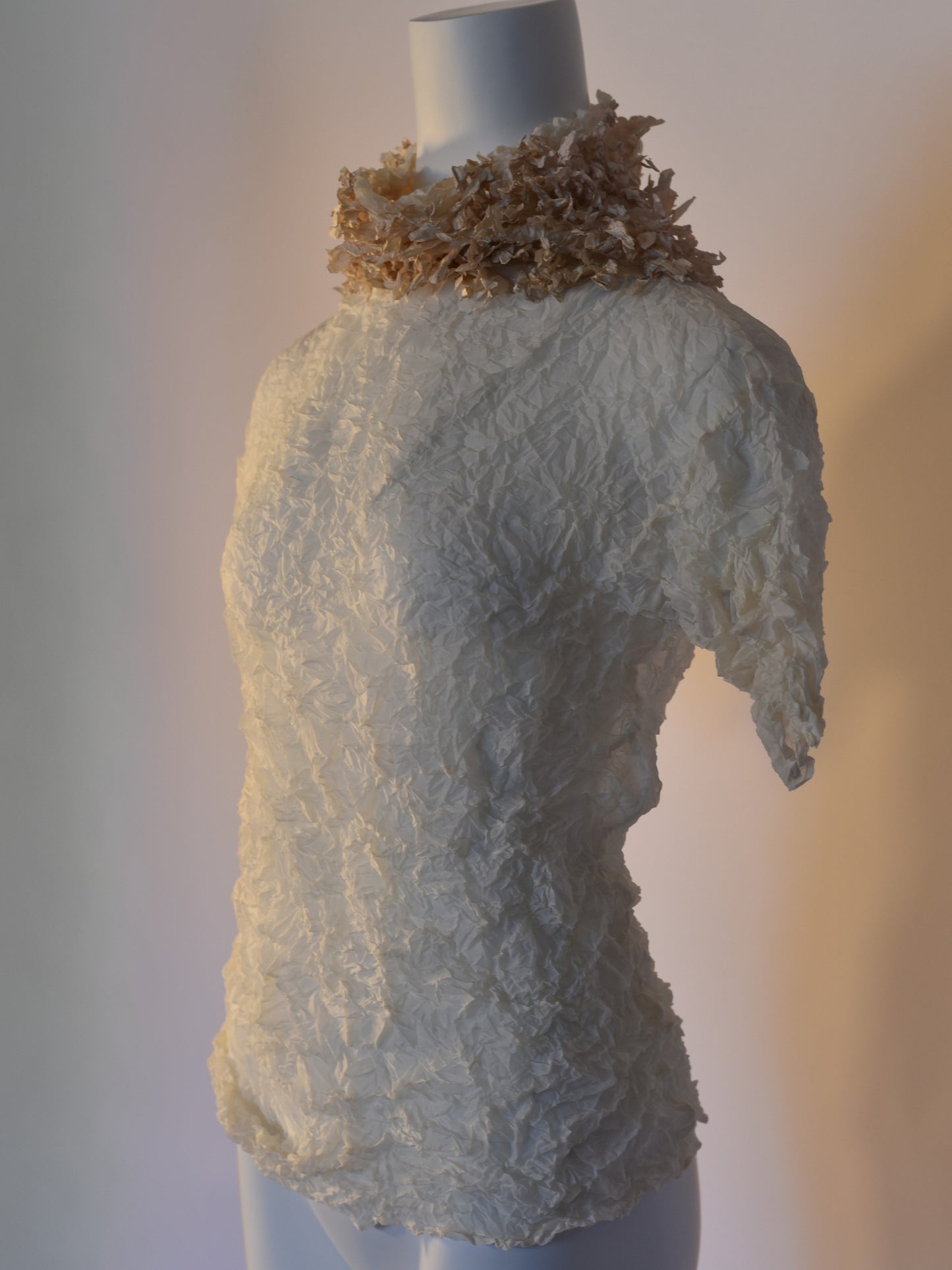 Side view of white label Issey Miyake crinkled blouse from S/S 2003 collection