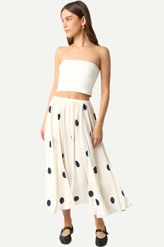 Siena Polka Dot Midi Skirt by Olivaceous styled on model with white bandeau top and ballet flats