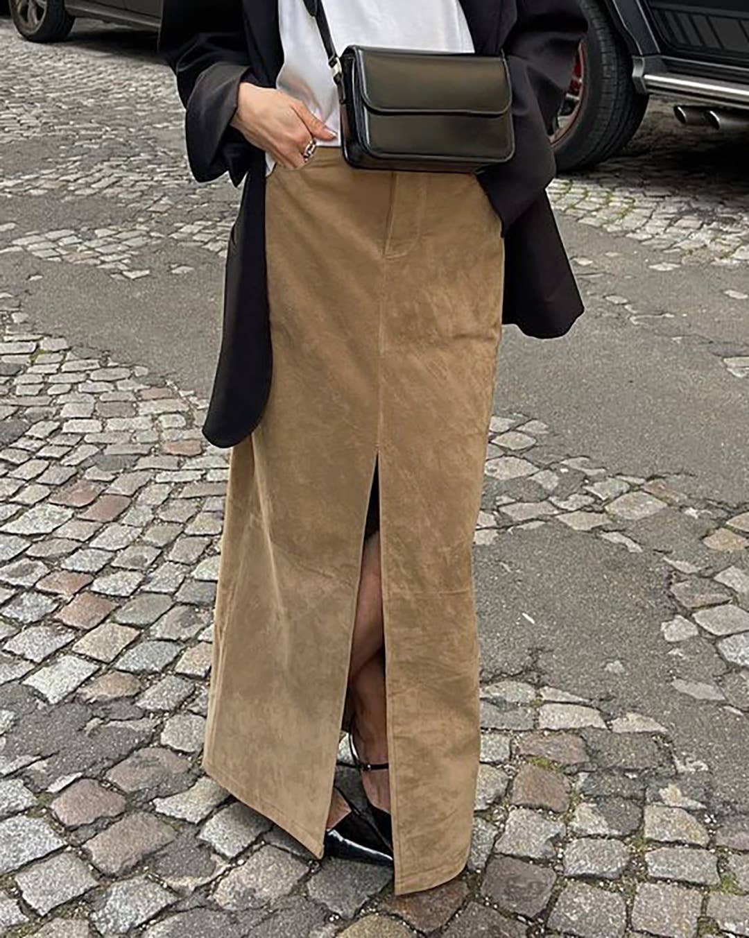 Camel faux suede midi skirt with front slit, styled with black leather purse