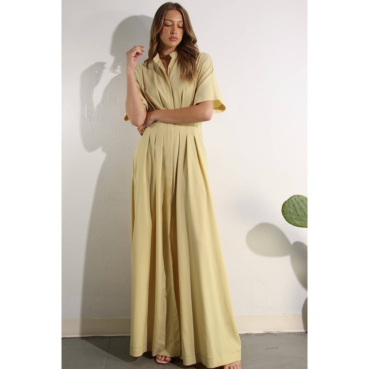 Flowing North and Five butter-yellow button-down dress with pleats and pockets, styled for spring/summer. 