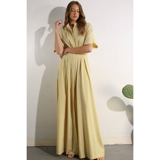 Flowing North and Five butter-yellow button-down dress with pleats and pockets, styled for spring/summer. 