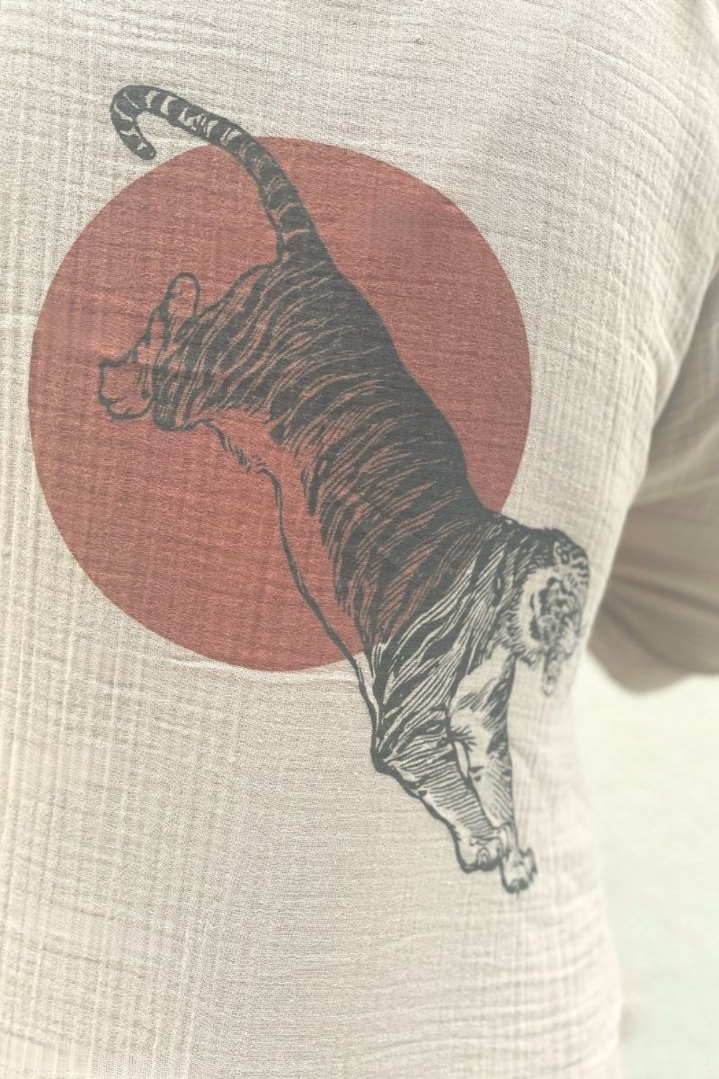 Closeup of tiger and sun design on beige muslin kimono