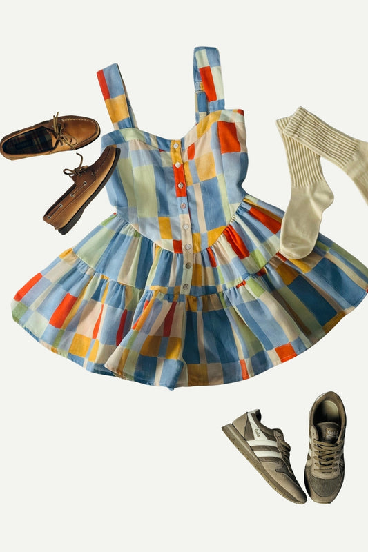 Colorful checkered dress with shoes and socks on a white background