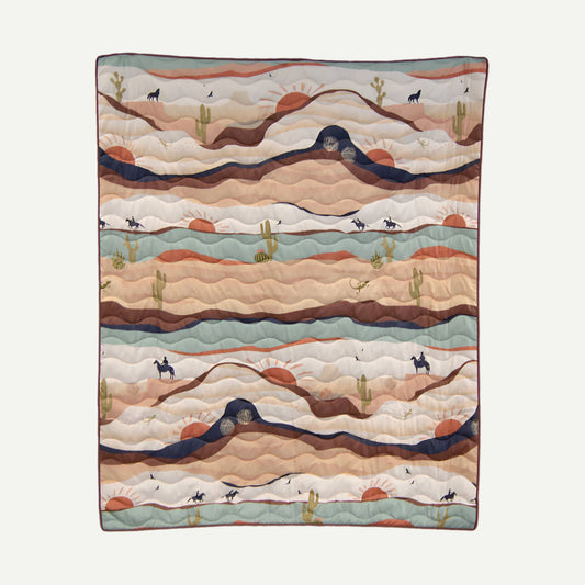 Earth-toned woven throw with cowboy, cactus and sun design. 