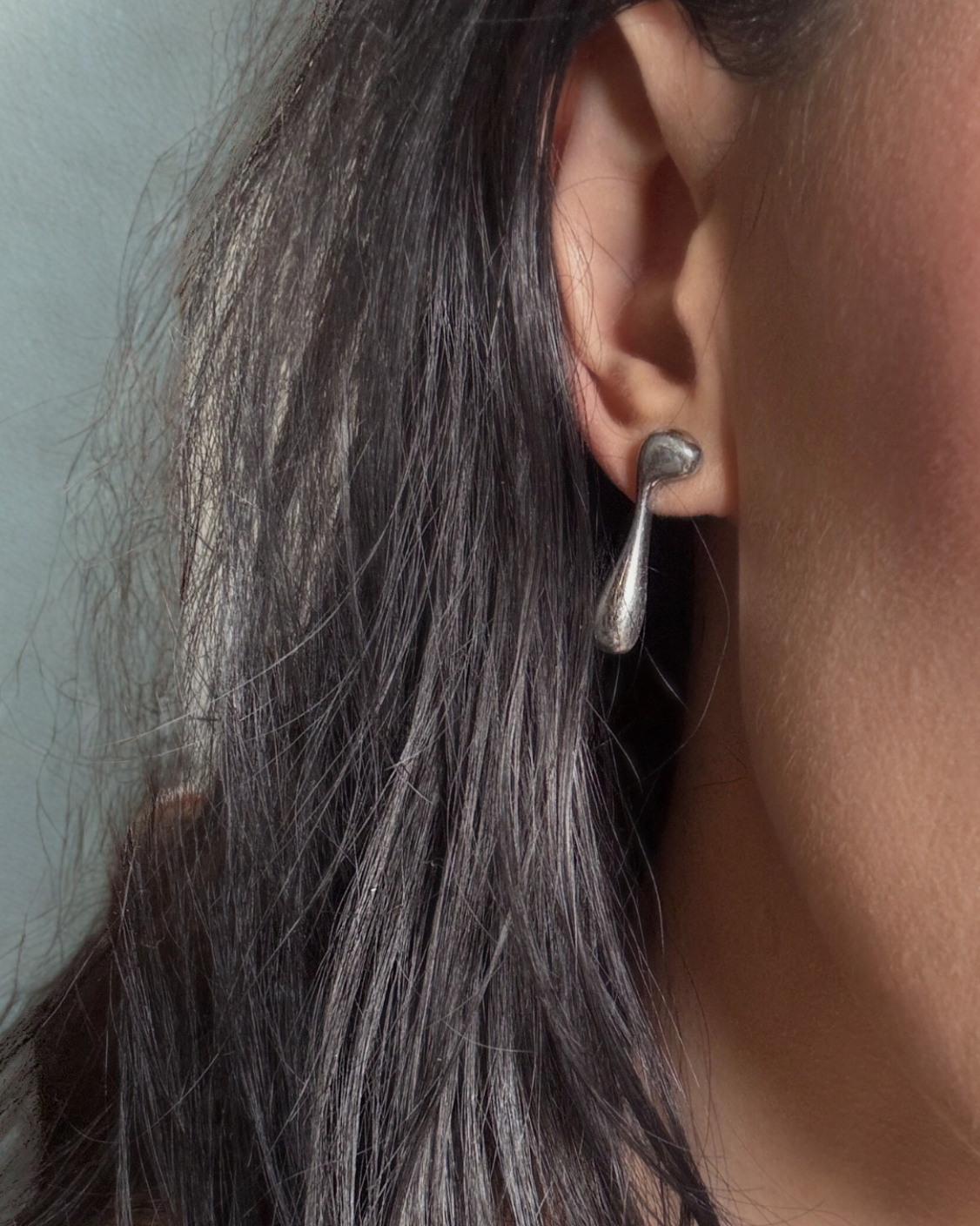 Close up of Vice Versa Stud on left ear of model. 